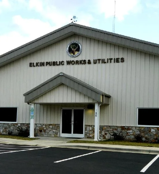 The Elkin Public Works and Utilities building, a gabled metal building with a covered entry.